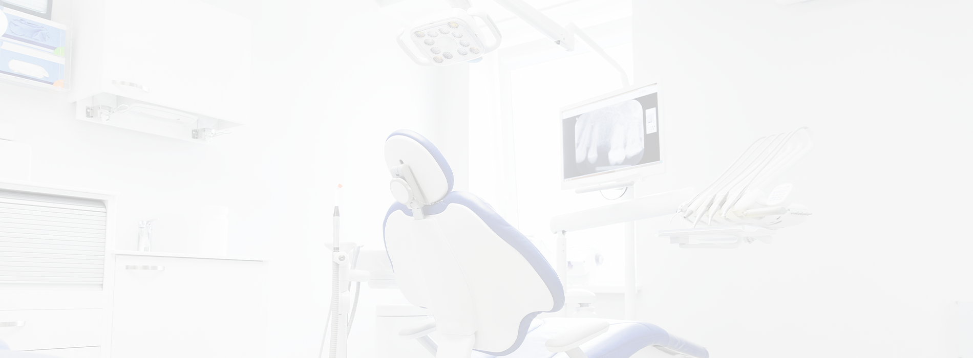 A modern dental office with a blue chair in front of a dental station, a large screen displaying medical images, and various dental equipment.